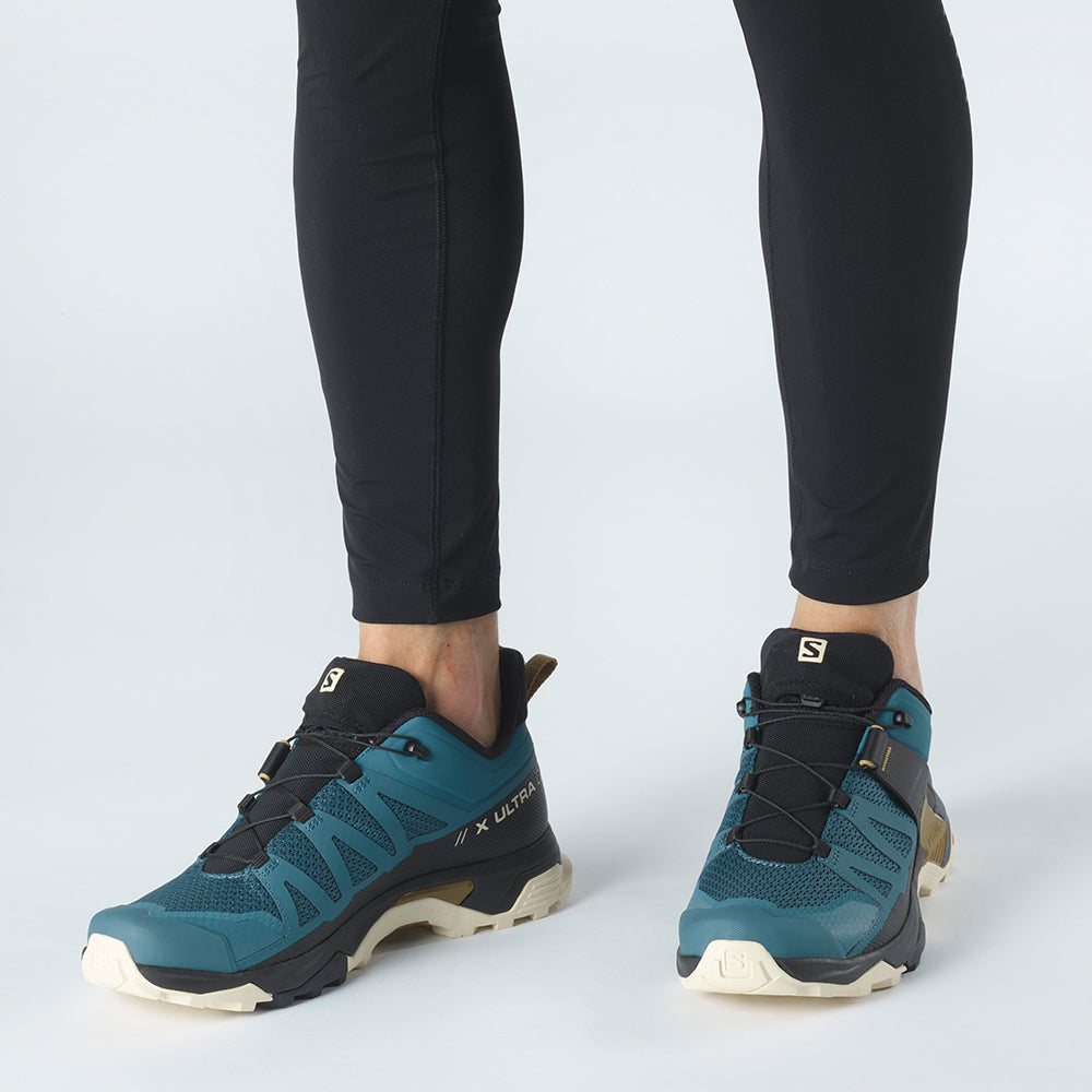 Salomon Sports X ULTRA 4 hiking footwear showing durable grey and black trail shoes with textured soles and supportive design.
