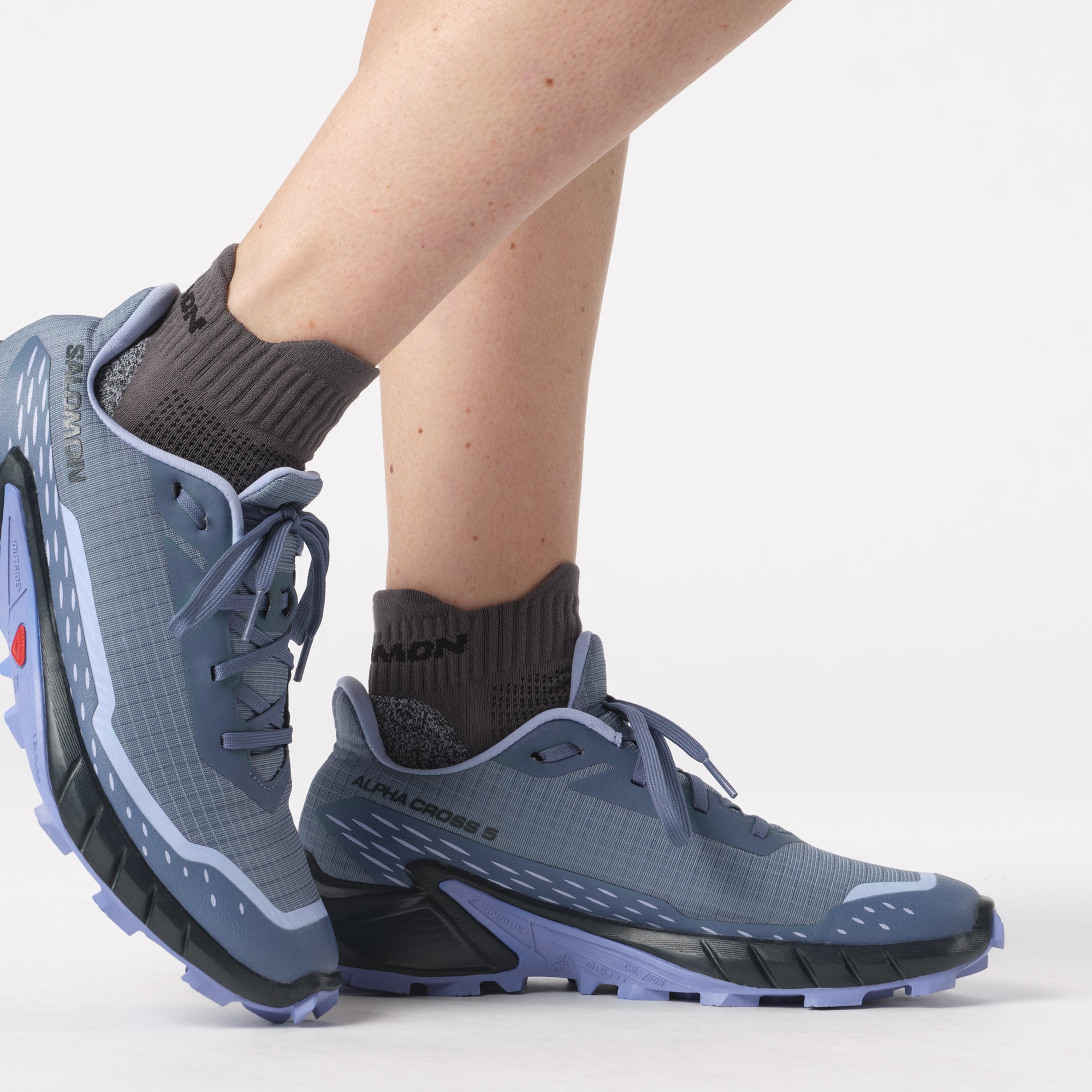 Salomon Sports ALPHACROSS 5 trail running shoes in black and red with rugged outsole and supportive design.