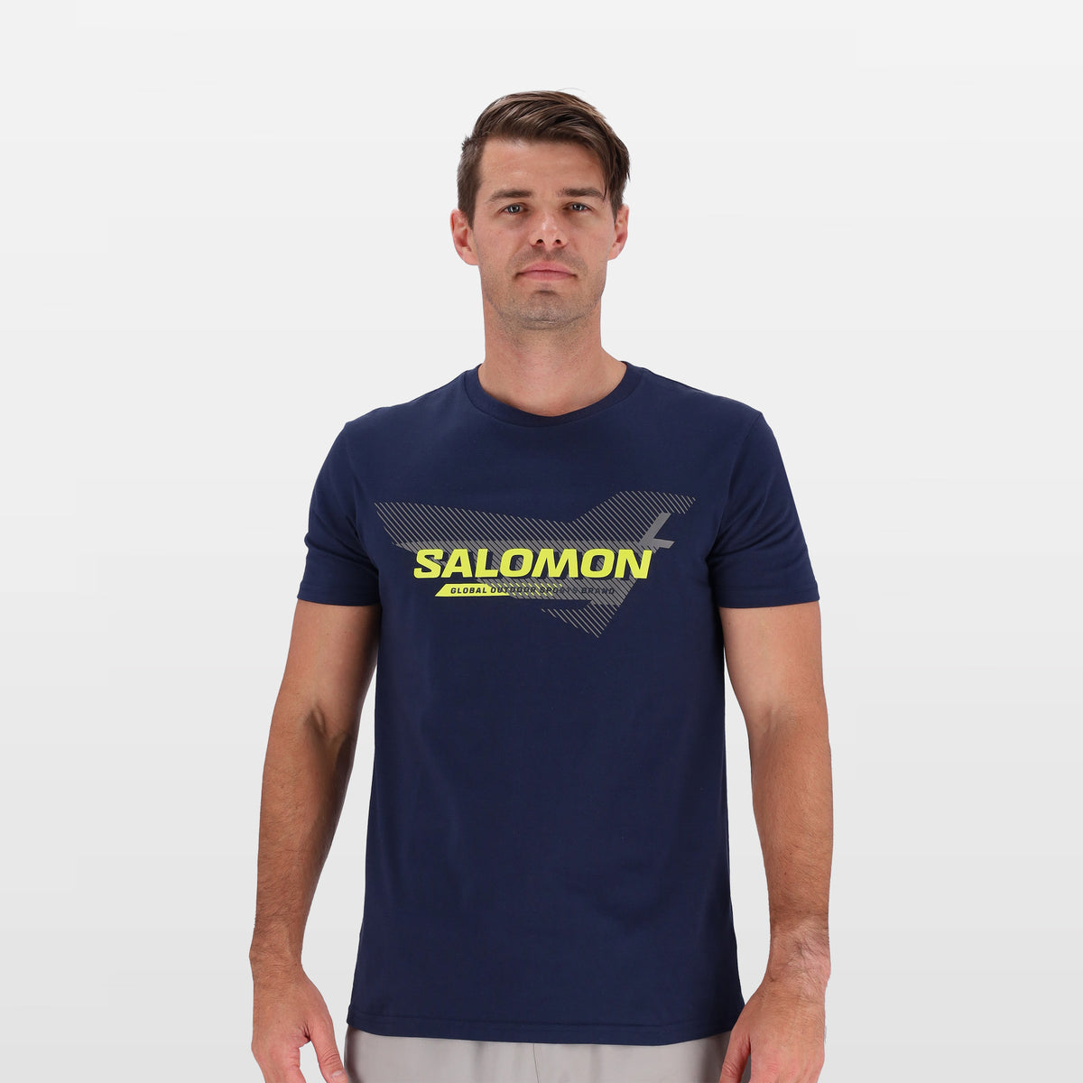 Salomon Sports ENDURO apparel in navy with orange accents, shown in close-up detail on fabric and design features.