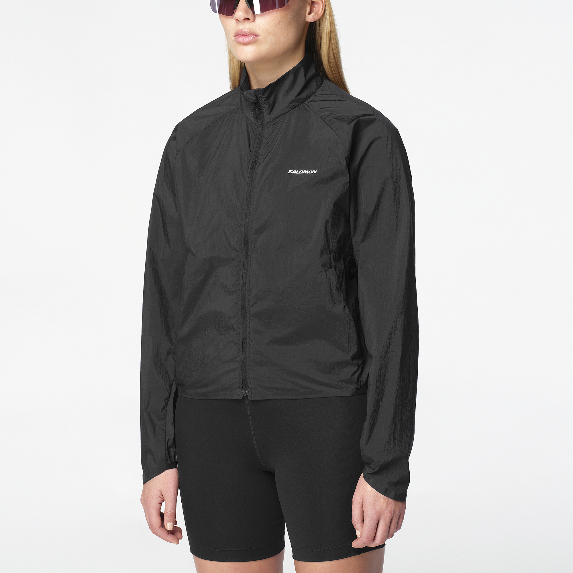 Salomon Sports Shakeout Fly apparel in deep black, lightweight jacket with a sleek design, suitable for running and outdoor activities.