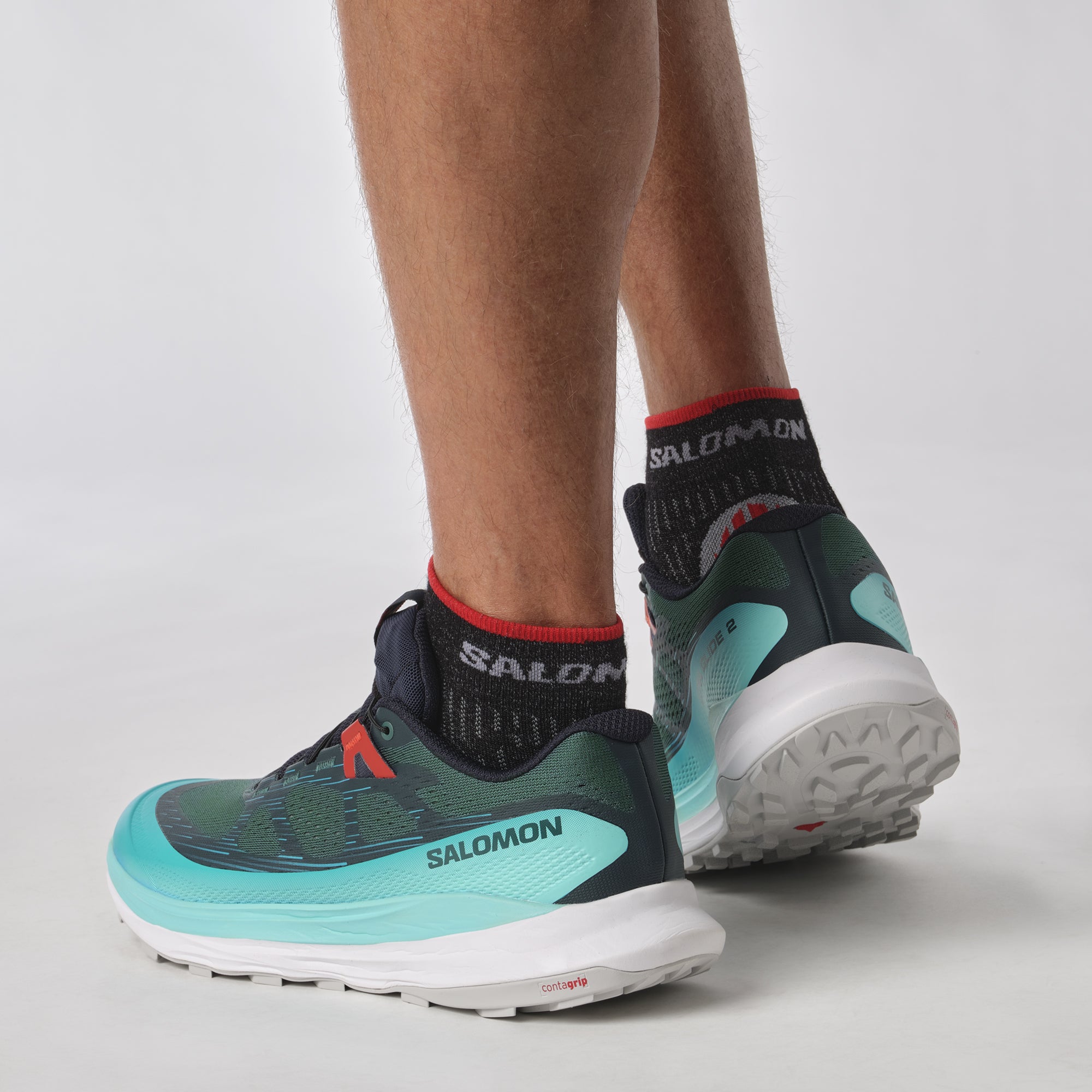 Salomon Sports Ultra Glide 2 footwear in black with white accents, featuring a sleek design and cushioned sole for outdoor activities.