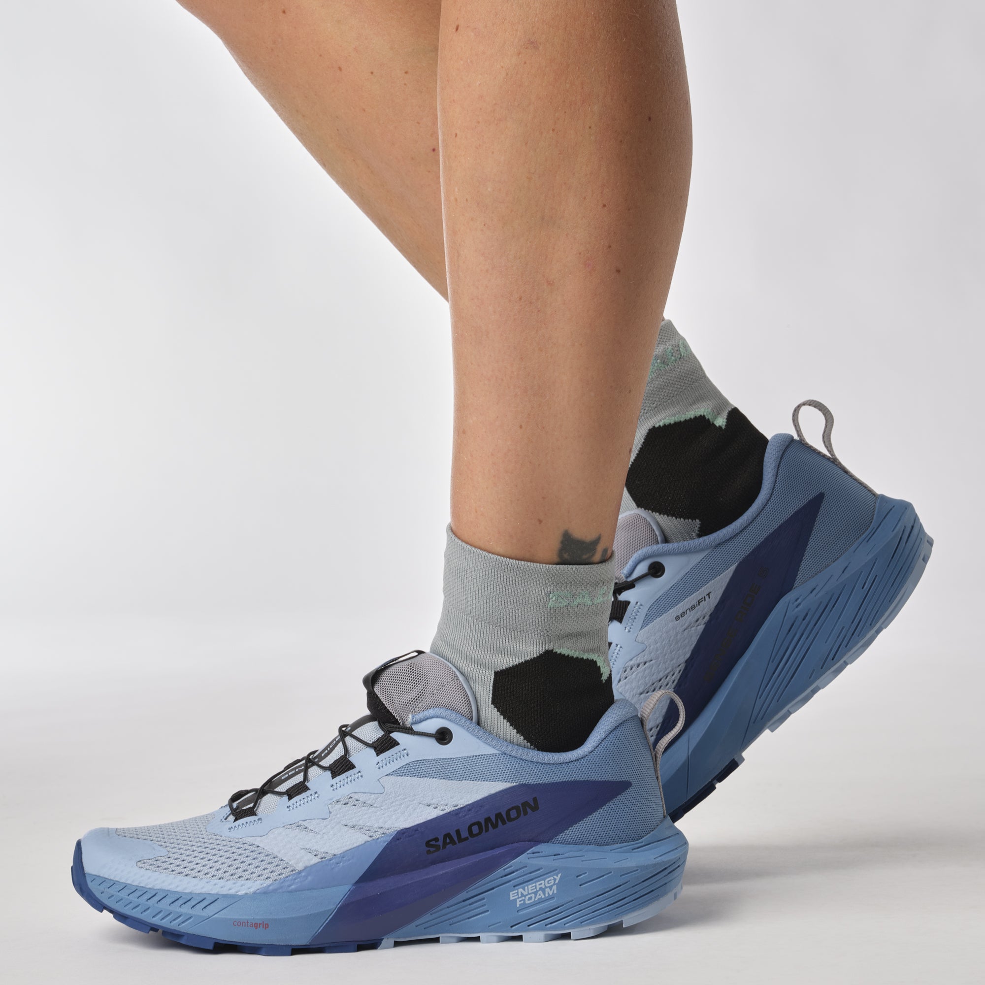 Salomon Sports Sense Ride 5 trail running shoes in black and gray with breathable mesh and sturdy soles.