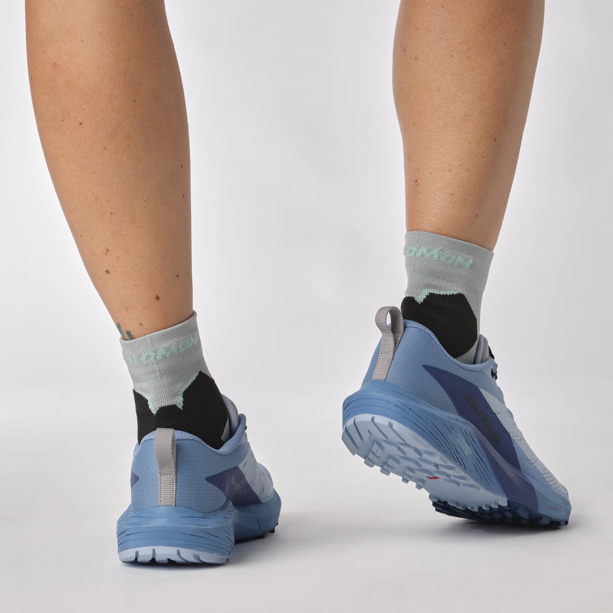 Salomon Sports SENSE RIDE 5 trail running shoes showing a side view with breathable mesh and supportive sole design.